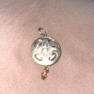 Double sided silver pendant with center sparkle.